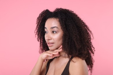 Photo of Beautiful Brazilian woman with healthy skin on pink background