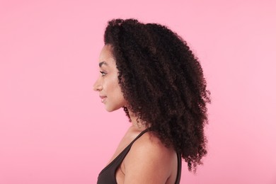 Photo of Beautiful Brazilian woman with healthy skin on pink background