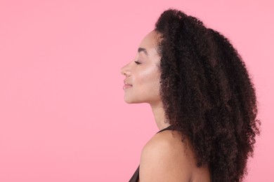 Photo of Beautiful Brazilian woman with healthy skin on pink background. Space for text