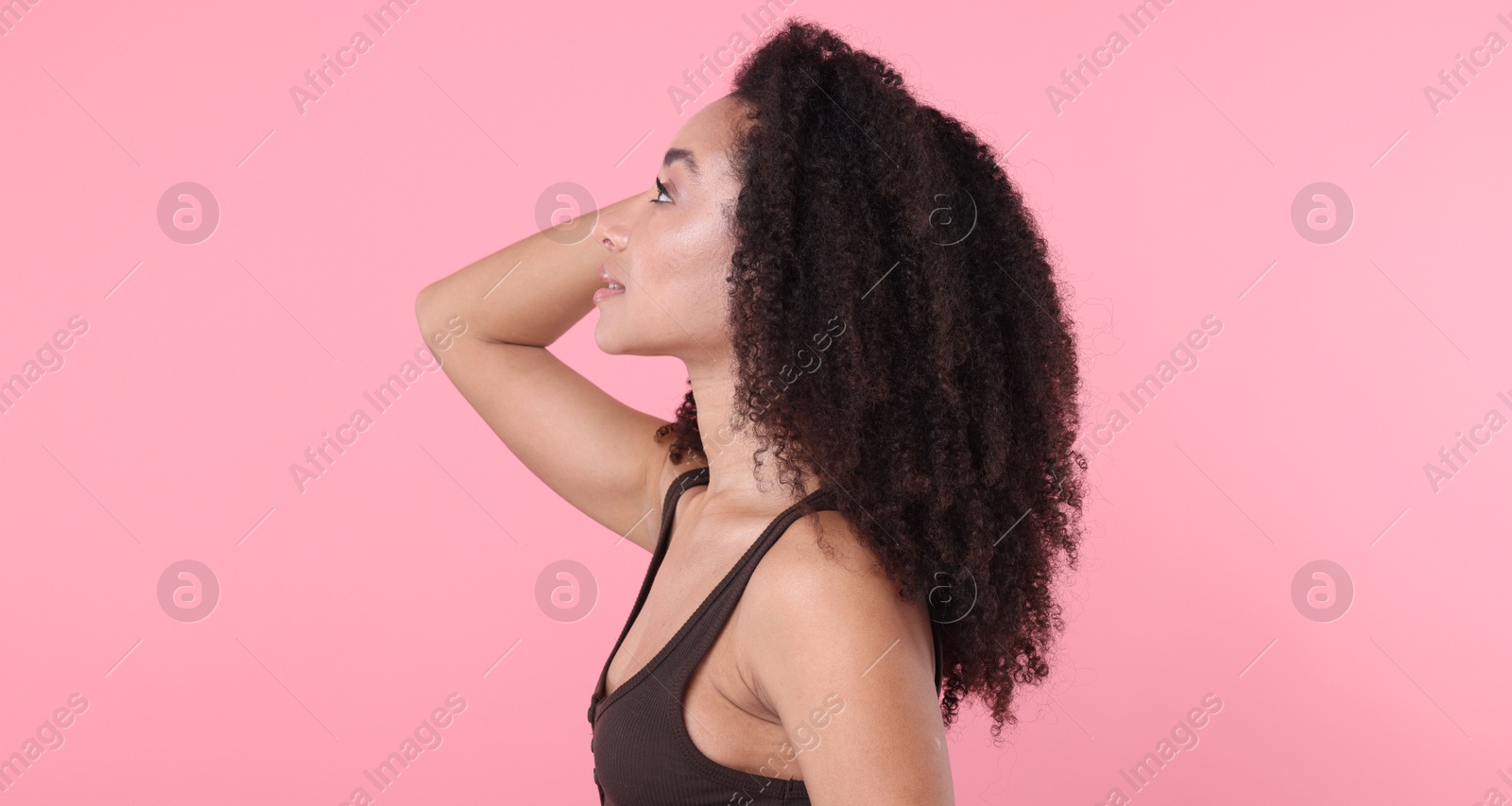 Beautiful Brazilian woman with healthy skin on pink background Photo of Beautiful Brazilian woman with healthy skin on pink background