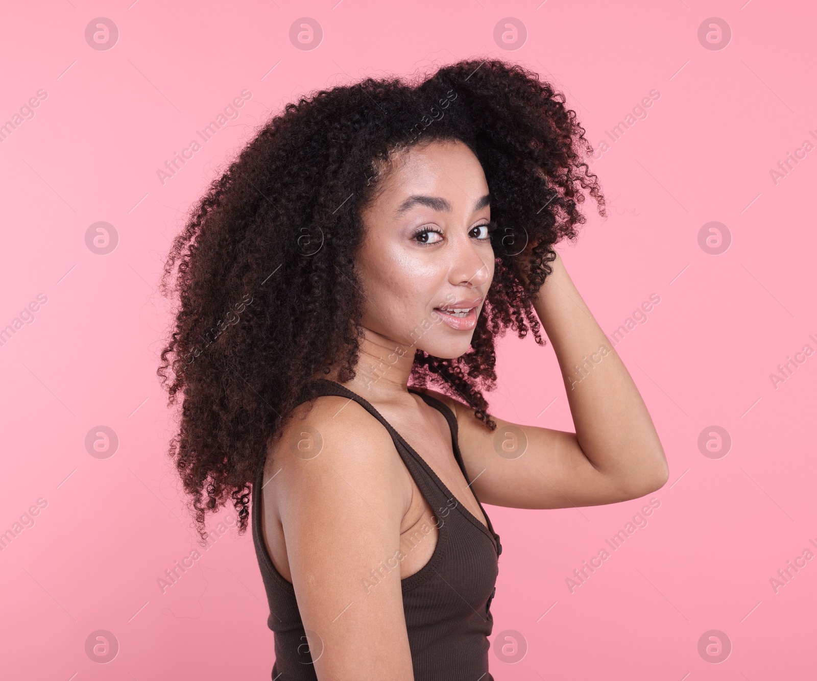 Beautiful Brazilian woman with healthy skin on pink background Photo of Beautiful Brazilian woman with healthy skin on pink background