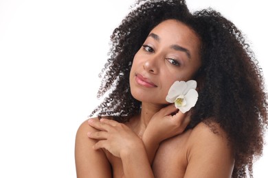 Photo of Portrait of beautiful Brazilian woman with orchid flower after spa treatment on white background