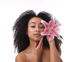 Photo of Portrait of beautiful Brazilian woman with lily flower after spa treatment on white background