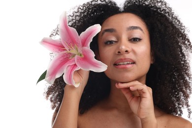 Photo of Portrait of beautiful Brazilian woman with lily flower after spa treatment on white background