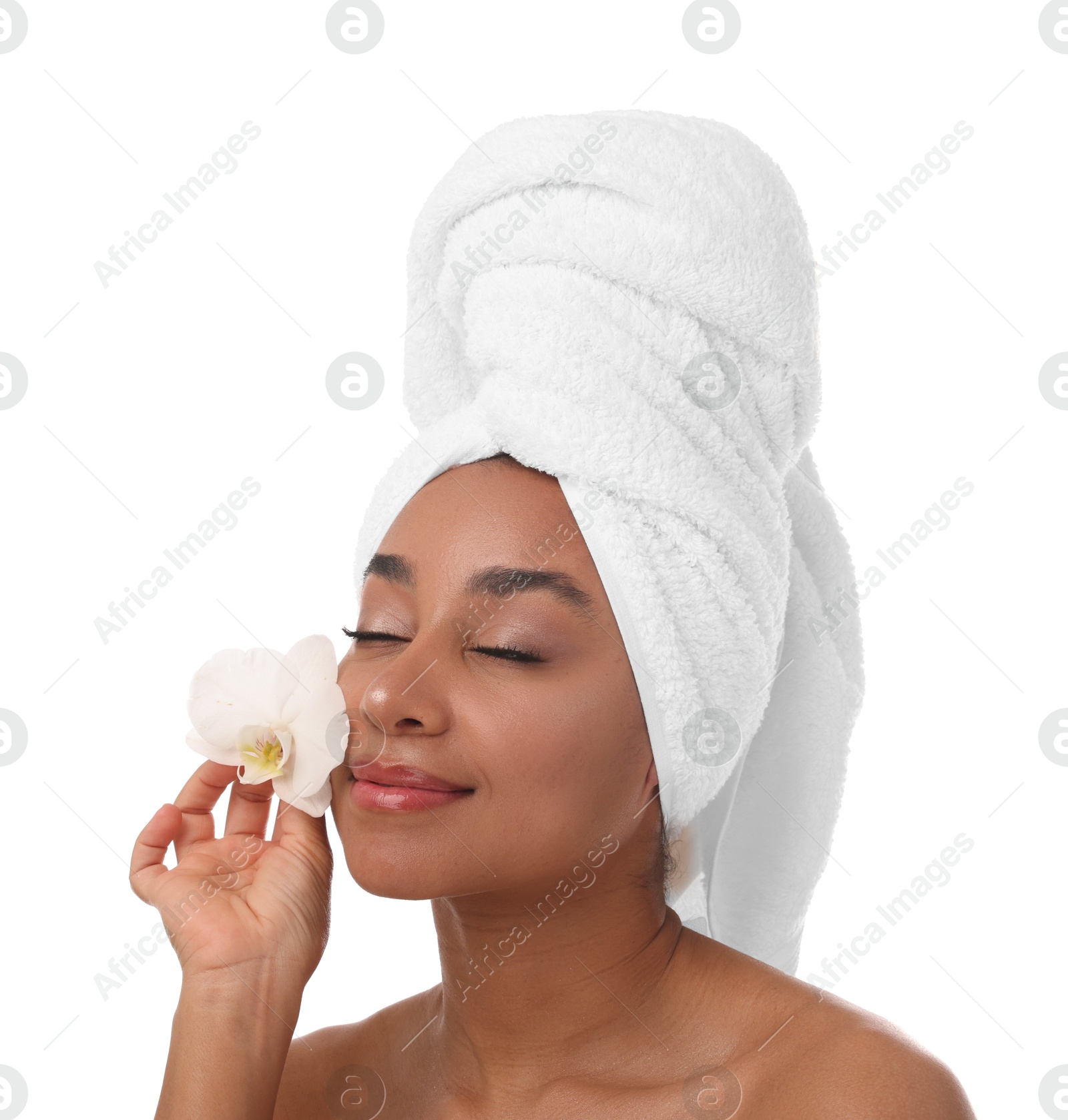 Portrait of beautiful Brazilian woman with orchid flower after spa treatment on white background Photo of Portrait of beautiful Brazilian woman with orchid flower after spa treatment on white background