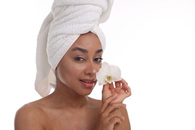 Photo of Portrait of beautiful Brazilian woman with orchid flower after spa treatment on white background