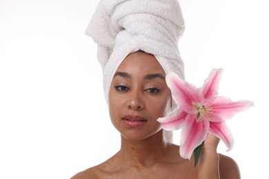 Photo of Portrait of beautiful Brazilian woman with lily flower after spa treatment on white background