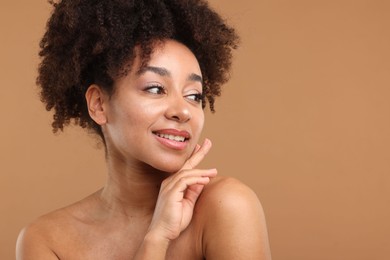 Photo of Portrait of beautiful Brazilian woman after spa treatment on light brown background. Space for text