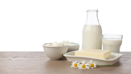 Photo of Different fresh dairy products and chamomile flowers on wooden table against white background