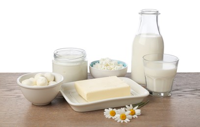 Photo of Different fresh dairy products and chamomile flowers on wooden table against white background