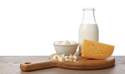 Photo of Different fresh dairy products and chamomile flowers on wooden table against white background