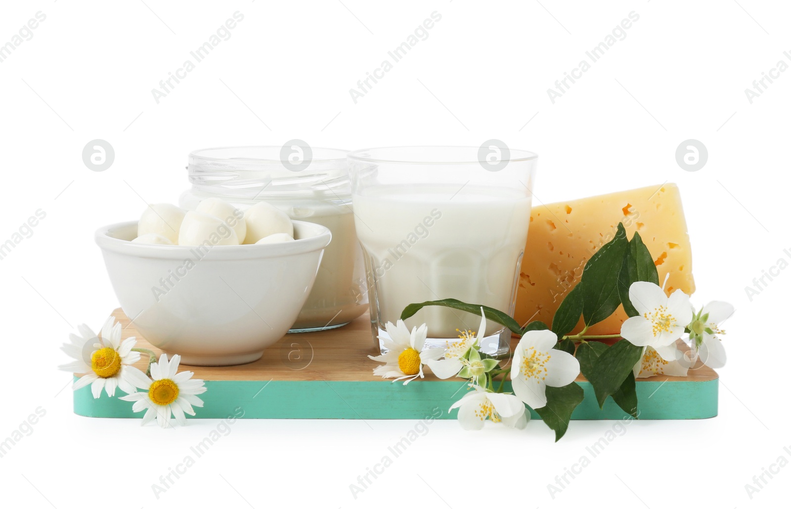 Different fresh dairy products and flowers isolated on white Photo of Different fresh dairy products and flowers isolated on white
