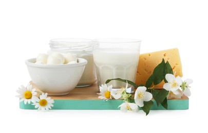 Photo of Different fresh dairy products and flowers isolated on white