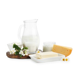 Photo of Different fresh dairy products and flowers isolated on white