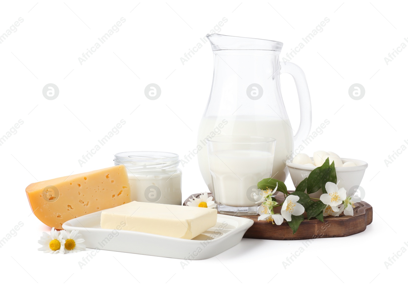 Different fresh dairy products and flowers isolated on white Photo of Different fresh dairy products and flowers isolated on white