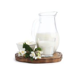 Photo of Different fresh dairy products and flowers isolated on white