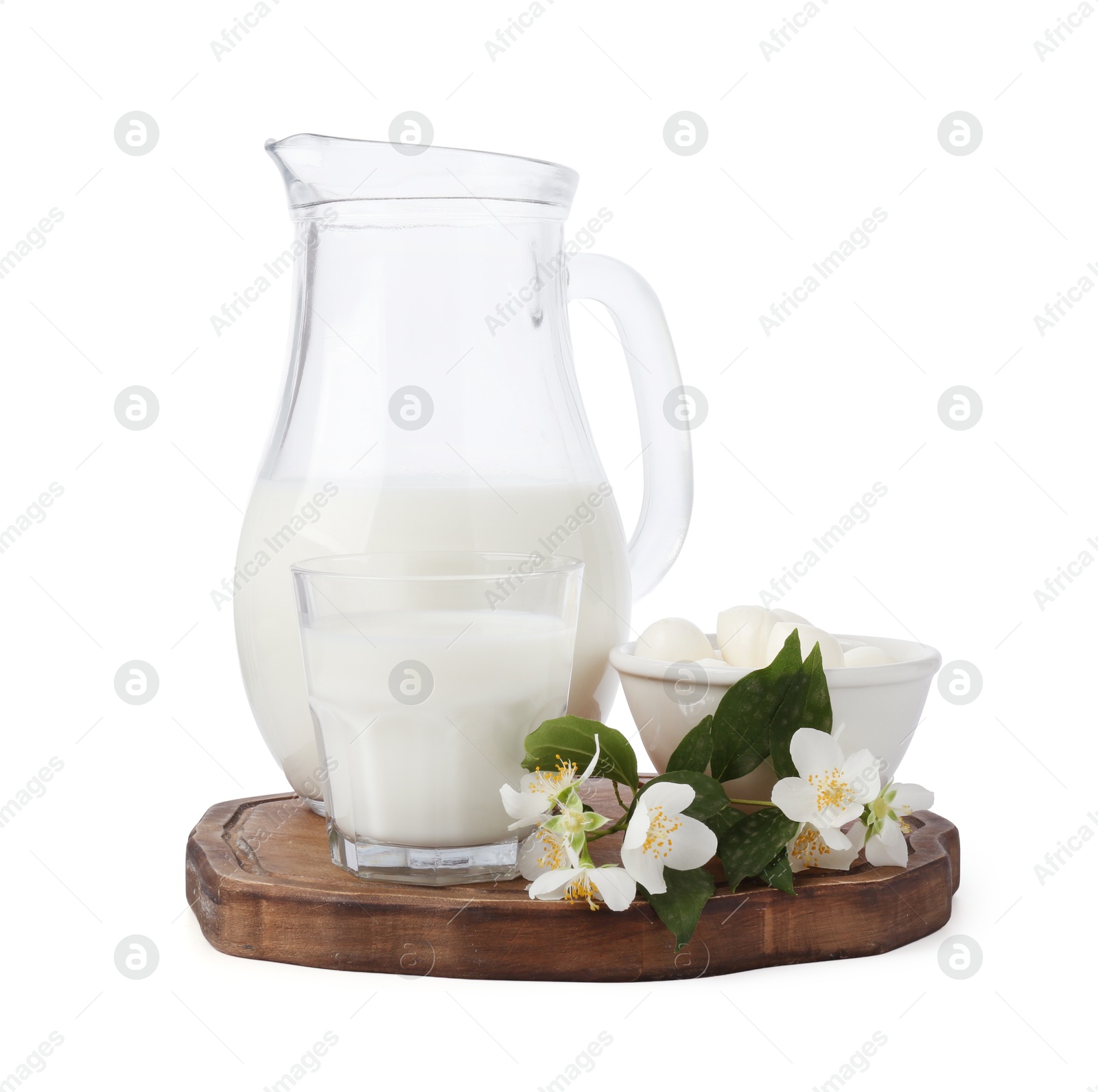 Photo of Different fresh dairy products and flowers isolated on white