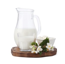 Photo of Different fresh dairy products and flowers isolated on white