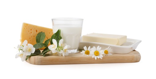 Photo of Different fresh dairy products and flowers isolated on white