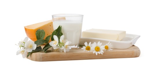 Photo of Different fresh dairy products and flowers isolated on white