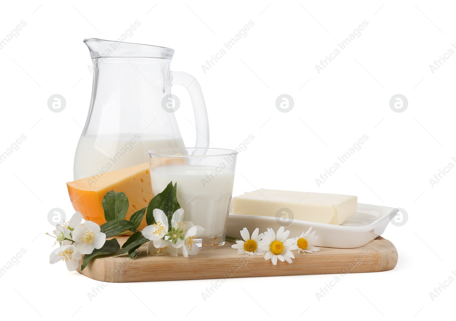 Photo of Different fresh dairy products and flowers isolated on white