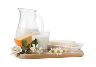 Photo of Different fresh dairy products and flowers isolated on white