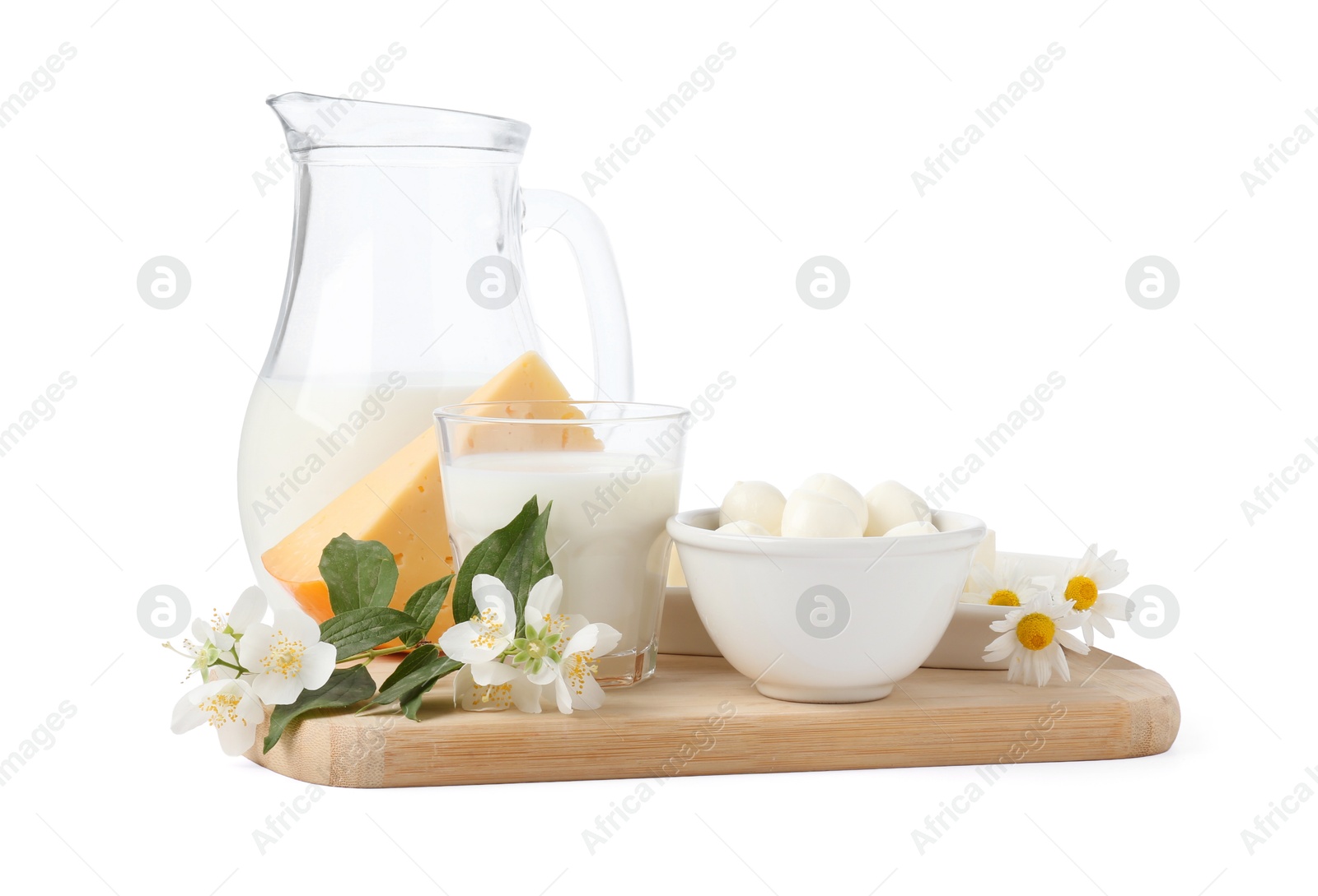 Different fresh dairy products and flowers isolated on white Photo of Different fresh dairy products and flowers isolated on white