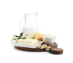 Photo of Different fresh dairy products and flowers isolated on white