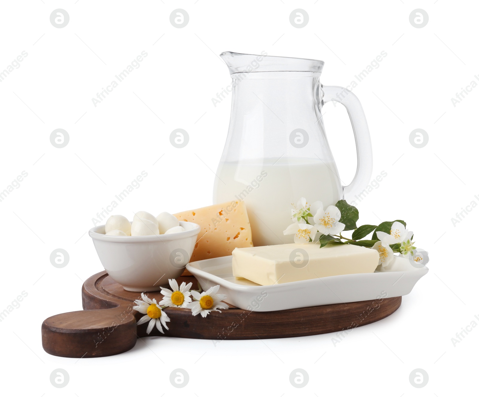 Photo of Different fresh dairy products and flowers isolated on white