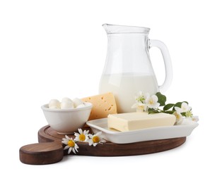 Photo of Different fresh dairy products and flowers isolated on white