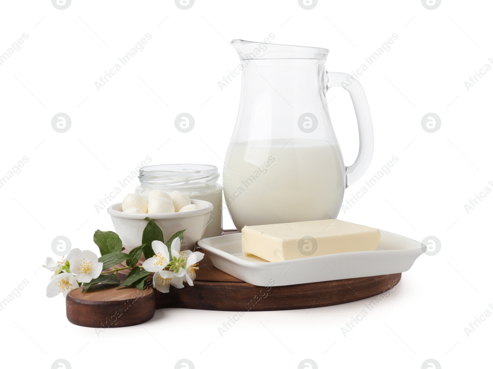 Different fresh dairy products and flowers isolated on white Photo of Different fresh dairy products and flowers isolated on white