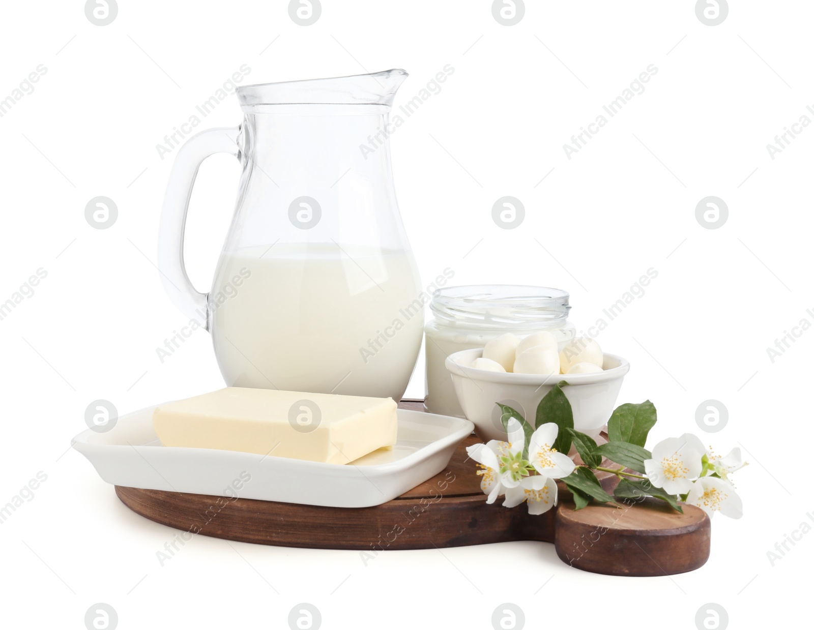 Different fresh dairy products and flowers isolated on white Photo of Different fresh dairy products and flowers isolated on white