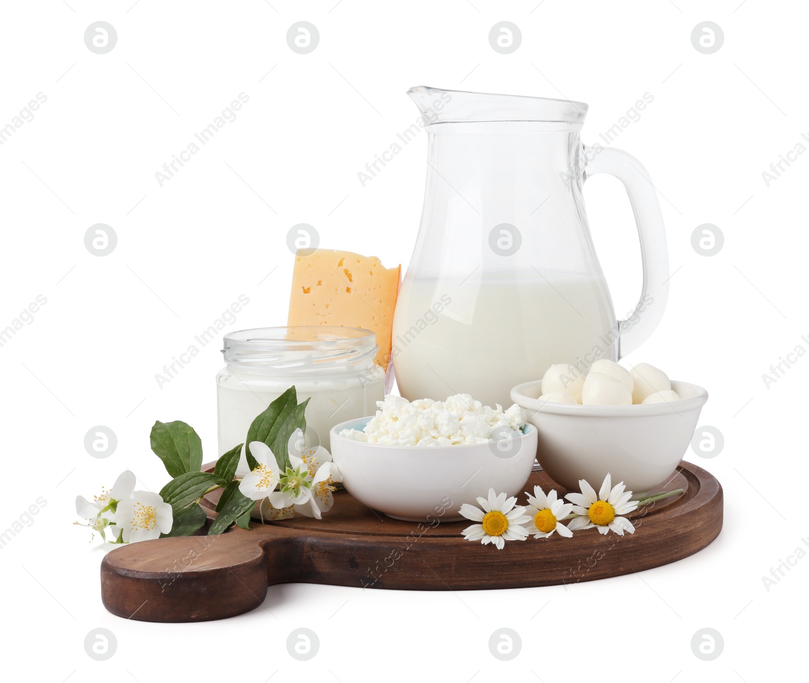 Different fresh dairy products and flowers isolated on white Photo of Different fresh dairy products and flowers isolated on white