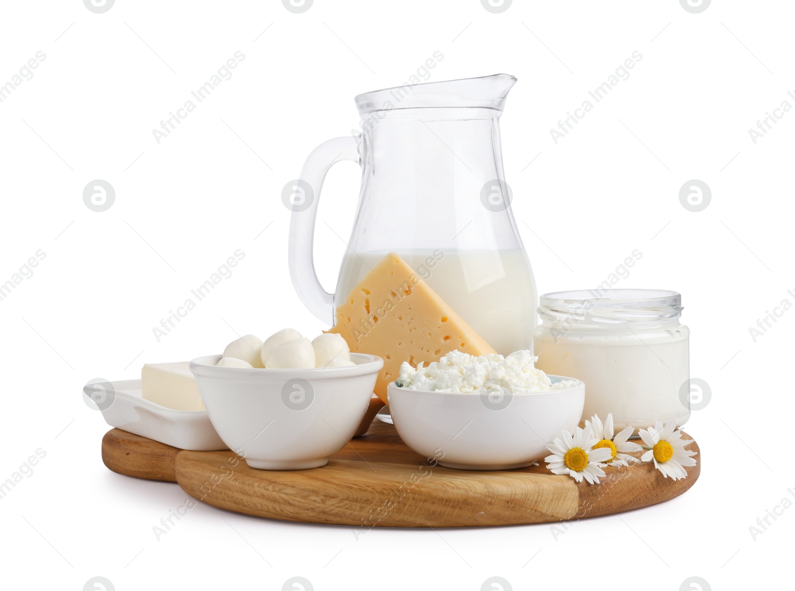 Photo of Different fresh dairy products and chamomile flowers isolated on white