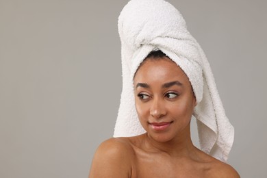 Photo of Portrait of beautiful Brazilian woman after spa treatment on gray background