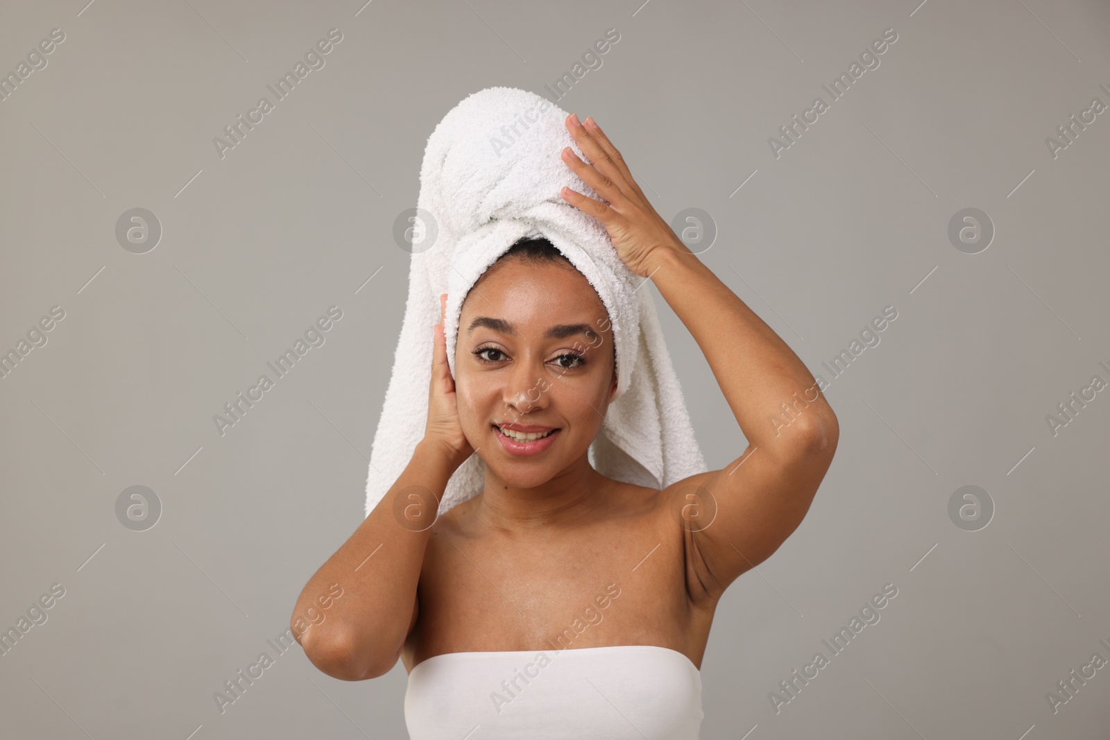 Portrait of beautiful Brazilian woman after spa treatment on gray background Photo of Portrait of beautiful Brazilian woman after spa treatment on gray background