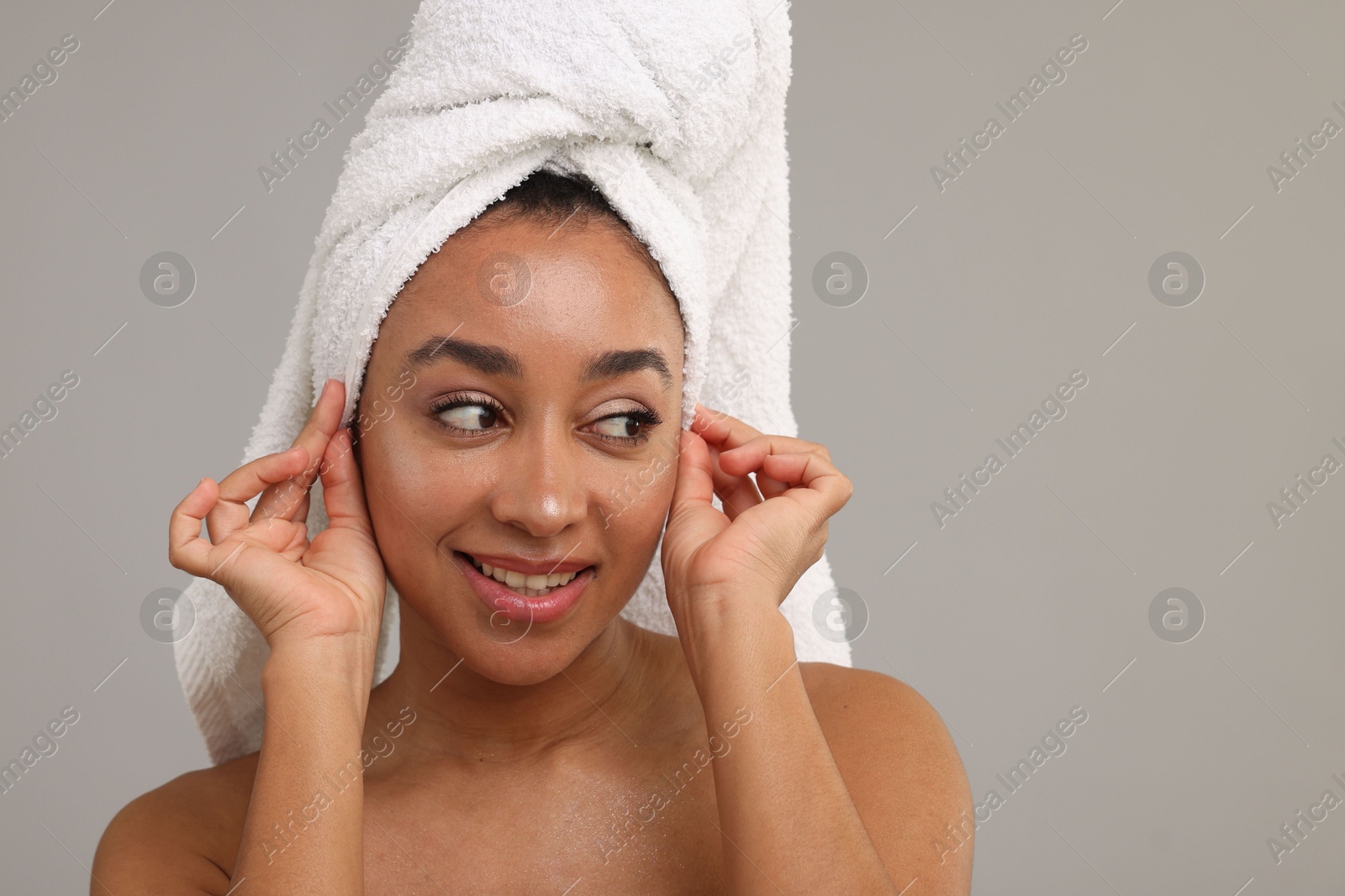 Portrait of beautiful Brazilian woman after spa treatment on gray background Photo of Portrait of beautiful Brazilian woman after spa treatment on gray background