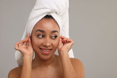 Photo of Portrait of beautiful Brazilian woman after spa treatment on gray background