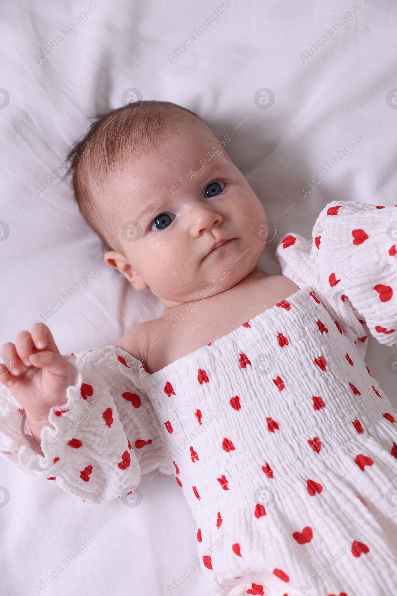 Cute newborn baby lying on bed, top view Photo of Cute newborn baby lying on bed, top view