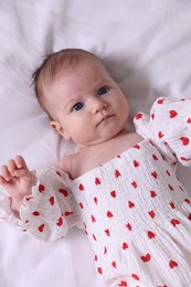 Photo of Cute newborn baby lying on bed, top view