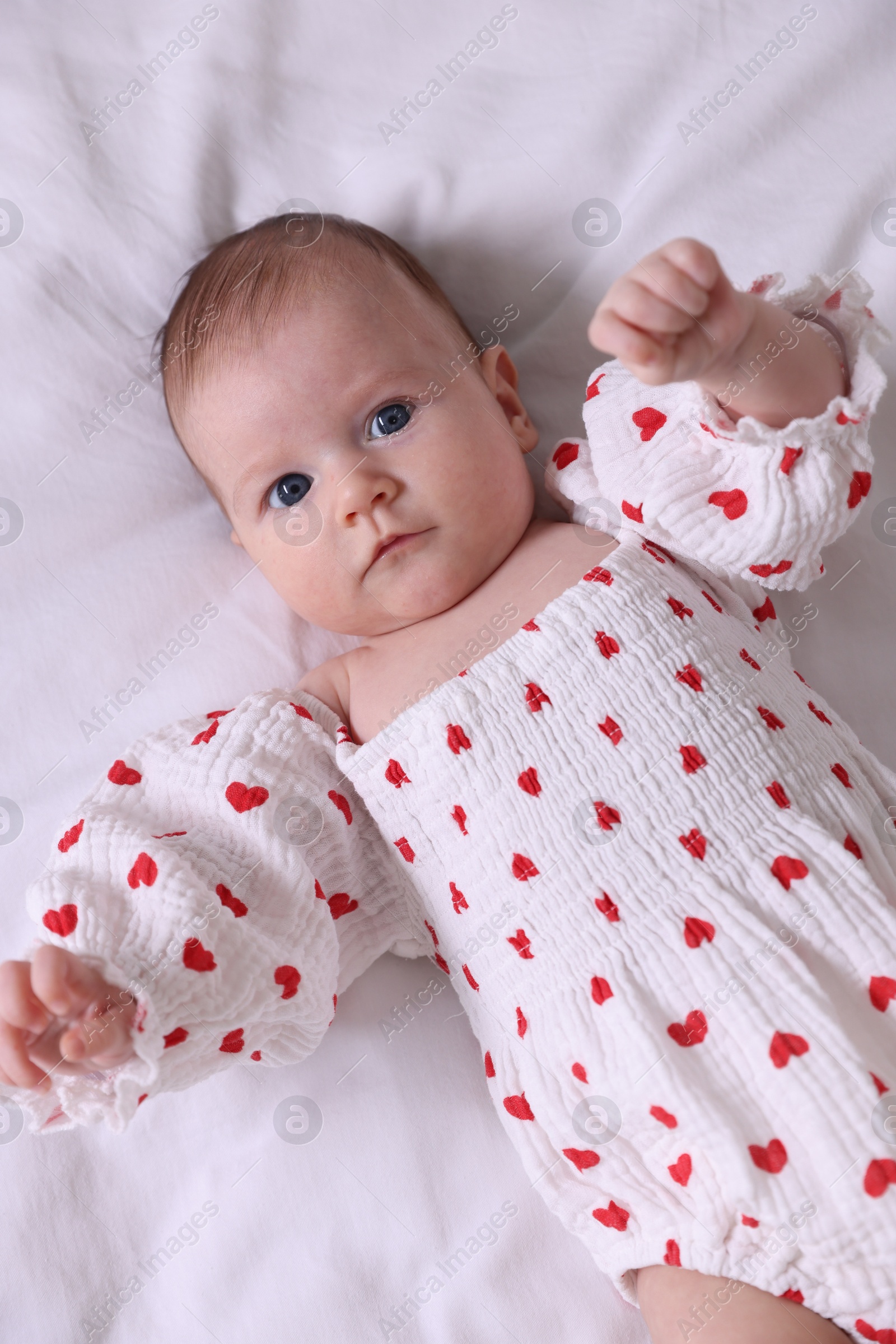 Cute newborn baby lying on bed, top view Photo of Cute newborn baby lying on bed, top view