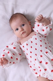 Photo of Cute newborn baby lying on bed, top view