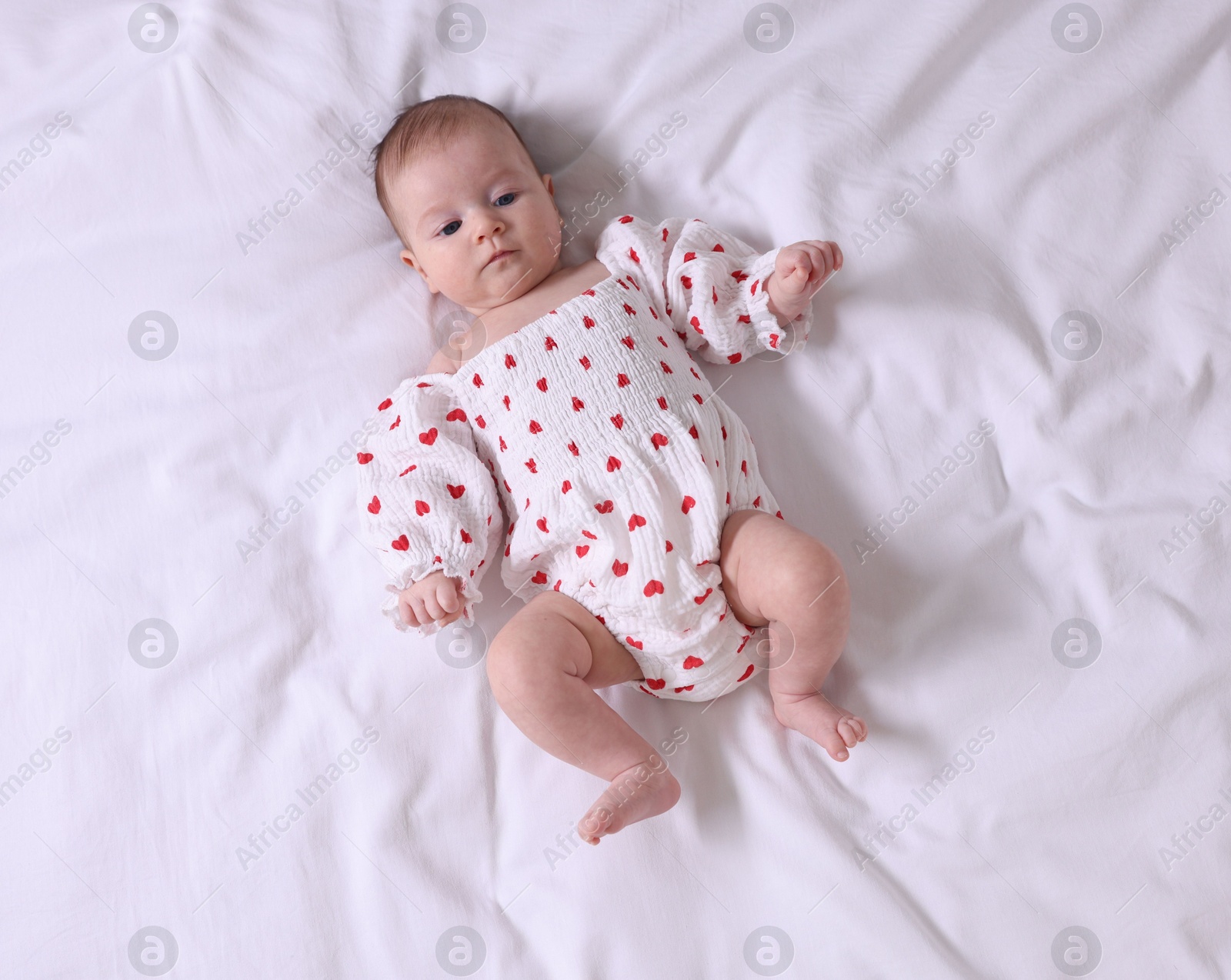 Cute newborn baby lying on bed, top view Photo of Cute newborn baby lying on bed, top view