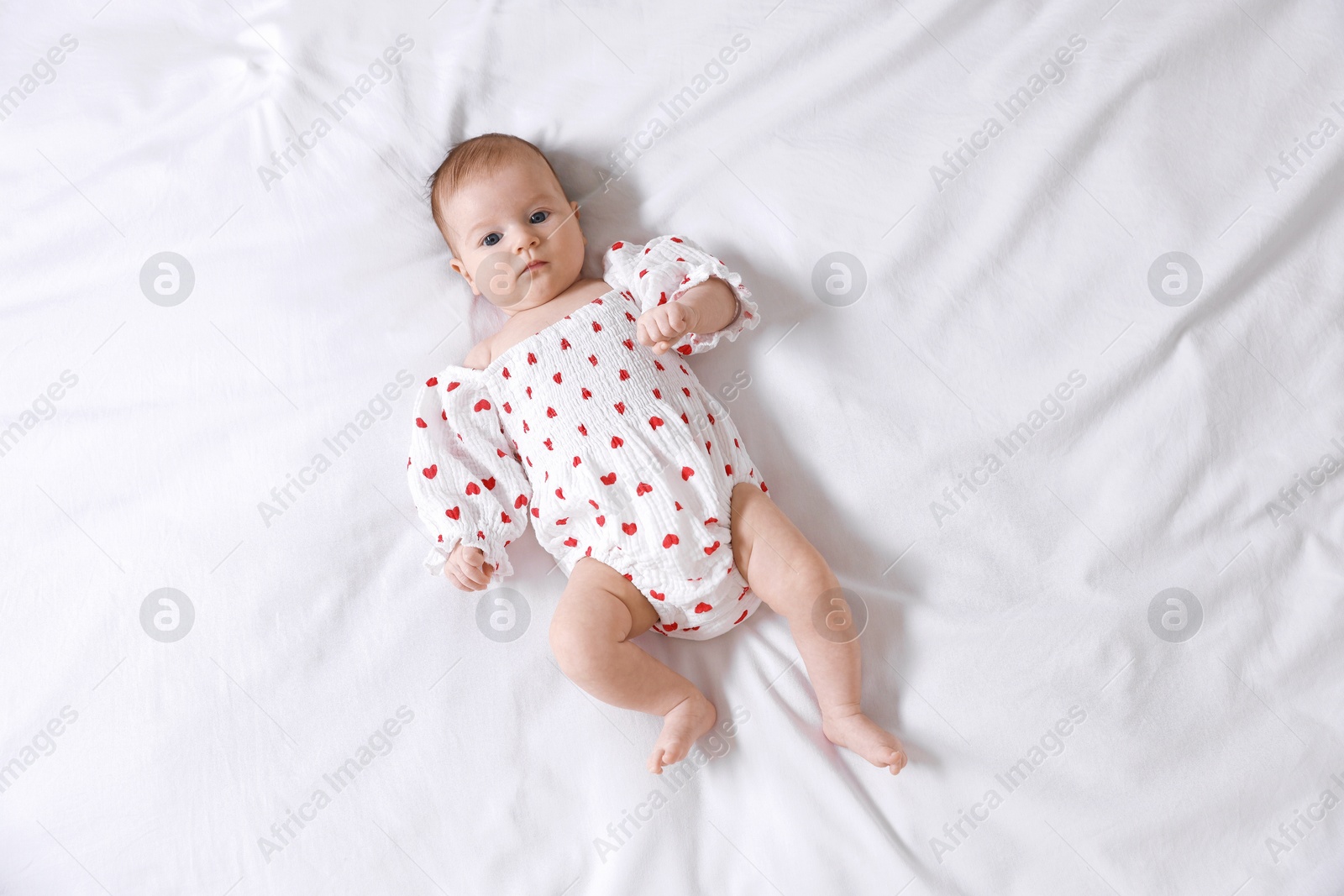 Cute newborn baby lying on bed, top view Photo of Cute newborn baby lying on bed, top view
