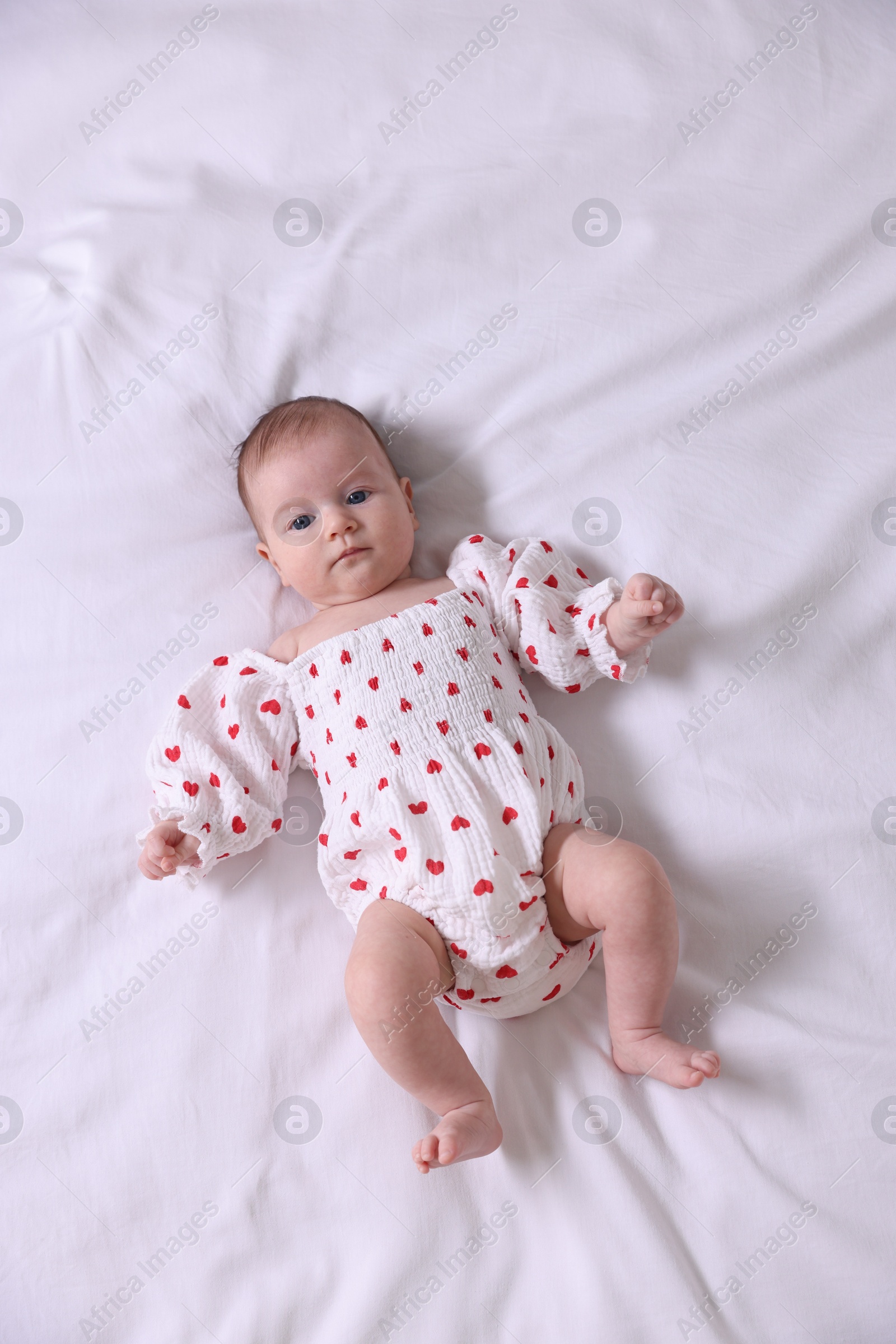 Cute newborn baby lying on bed, top view Photo of Cute newborn baby lying on bed, top view