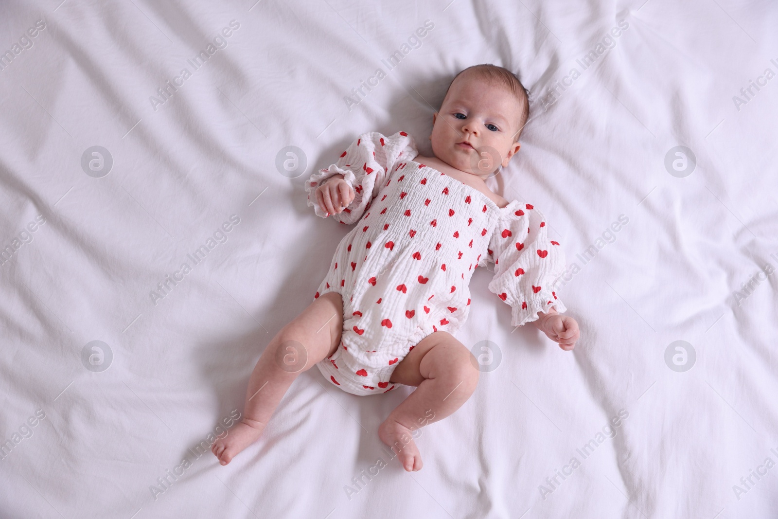 Cute newborn baby lying on bed, top view Photo of Cute newborn baby lying on bed, top view