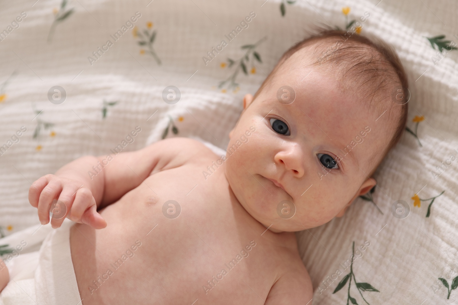 Cute newborn baby lying on bed, top view Photo of Cute newborn baby lying on bed, top view