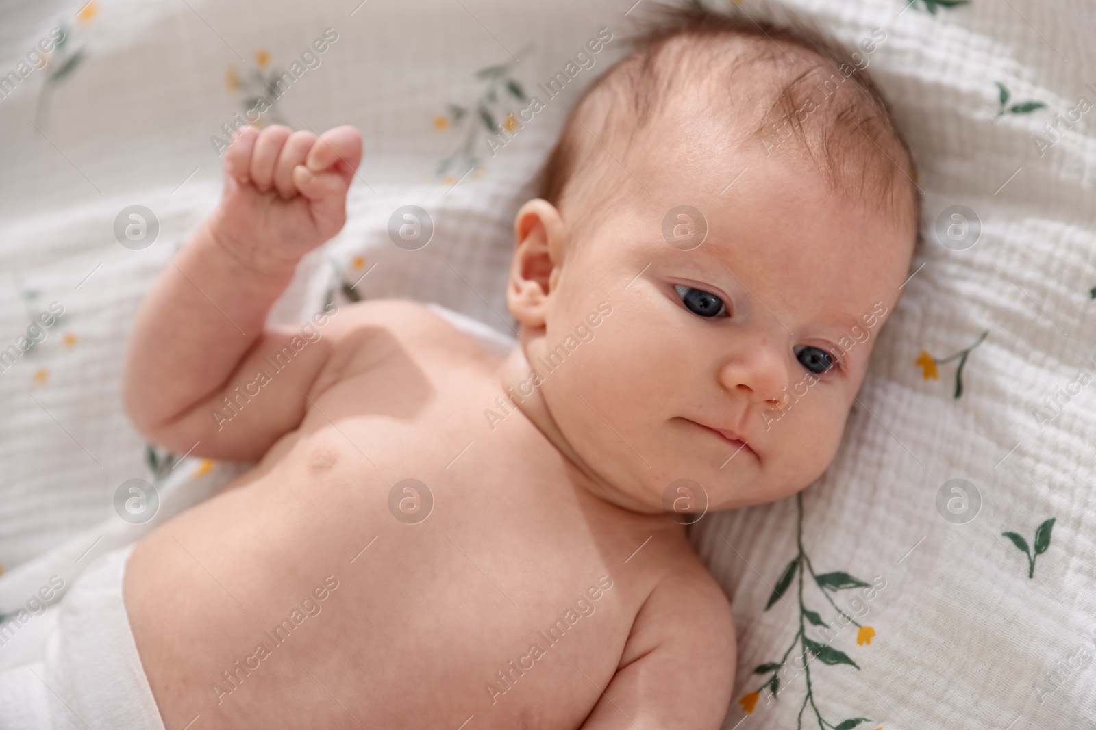 Cute newborn baby lying on bed, top view Photo of Cute newborn baby lying on bed, top view