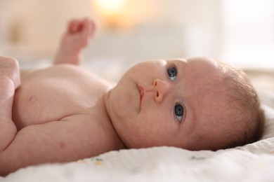 Photo of Cute newborn baby lying on bed, closeup