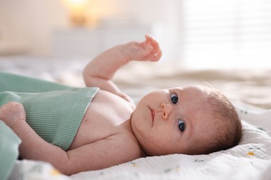Photo of Cute newborn baby lying on bed, closeup